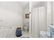 Bathroom features a pedestal sink, wainscotting and decorative mirror at 3021 Alton Dr, St Pete Beach, FL 33706