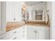 Stylish bathroom featuring custom cabinets, elegant hardware, granite counters, and decorative shelving at 3021 Alton Dr, St Pete Beach, FL 33706