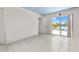 A bright bedroom with tile floors and a sliding glass door to the backyard at 3021 Alton Dr, St Pete Beach, FL 33706