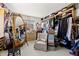 Spacious closet with built-in shelving, storage, chair and large mirror at 3021 Alton Dr, St Pete Beach, FL 33706