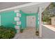 Welcoming front porch with stylish double doors, lush landscaping, and a glimpse of the beautiful waterfront at 3021 Alton Dr, St Pete Beach, FL 33706