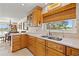 View of the kitchen countertop and sink area, with wooden cabinets, a window, and stainless steel appliances at 3021 Alton Dr, St Pete Beach, FL 33706