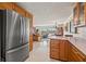 Bright kitchen offering stainless steel refrigerator and view to living spaces with water views at 3021 Alton Dr, St Pete Beach, FL 33706