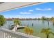 A beautiful water view shows the waterway behind the home, with private dock and boat at 3021 Alton Dr, St Pete Beach, FL 33706