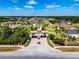 This aerial view reveals the entrance to a beautiful residential community, highlighted by manicured greenery and a central roundabout at 304 Hawk Talon Dr, Lithia, FL 33547