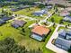 An aerial view showcases a home with a screened pool and lush landscaping in a neighborhood with well-maintained lawns at 304 Hawk Talon Dr, Lithia, FL 33547