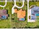 Stunning aerial view of a luxury home with a terracotta roof, circular driveway, pool, and lush landscaping at 304 Hawk Talon Dr, Lithia, FL 33547