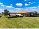 A well-manicured lawn stretches out behind a single-story home with a screened-in patio at 304 Hawk Talon Dr, Lithia, FL 33547