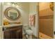 Full bathroom featuring tiled walk-in shower, granite counter tops, and decorative round mirror at 304 Hawk Talon Dr, Lithia, FL 33547