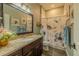 Charming bathroom with granite counters, decorative floral shower curtain, and earth-toned walls at 304 Hawk Talon Dr, Lithia, FL 33547