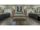 A luxurious bathroom with dual vanities, a soaking tub, and dual walk-in showers at 304 Hawk Talon Dr, Lithia, FL 33547