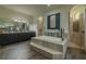 This elegant bathroom showcases dual vanities, a central soaking tub, and private showers at 304 Hawk Talon Dr, Lithia, FL 33547