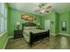 Spacious bedroom with hardwood floors, ceiling fan, artwork, and stylish decor at 304 Hawk Talon Dr, Lithia, FL 33547