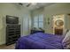 Lovely bedroom featuring a ceiling fan, wood floors, closet, and neutral decor at 304 Hawk Talon Dr, Lithia, FL 33547
