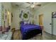 Comfortable bedroom featuring a ceiling fan, wood floors, closet, and bright decor at 304 Hawk Talon Dr, Lithia, FL 33547