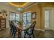 Casual dining area with wood floors, black chairs, and large windows overlooking the outdoor pool area at 304 Hawk Talon Dr, Lithia, FL 33547