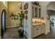 Inviting entryway with wood floors, a bar area, and tasteful decor sets an elegant tone for the home at 304 Hawk Talon Dr, Lithia, FL 33547