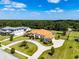 Expansive home exterior featuring a circular driveway, lush lawn, with a detached garage and additional green space at 304 Hawk Talon Dr, Lithia, FL 33547