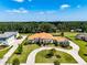 Beautiful exterior of a white stucco home with a terracotta roof, curved entryway, and meticulously manicured front yard at 304 Hawk Talon Dr, Lithia, FL 33547