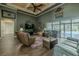 Spacious living room with tall ceilings, fan, wood floors, comfortable seating, and access to a screened pool area at 304 Hawk Talon Dr, Lithia, FL 33547