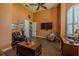 Relaxing living room featuring wood floors, arched window, ceiling fan, and stylish decor at 304 Hawk Talon Dr, Lithia, FL 33547