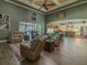 Expansive living room with pool view, wood floors, high ceilings, ample seating, and open access to other living spaces at 304 Hawk Talon Dr, Lithia, FL 33547