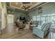 Large living room featuring wood floors, high ceilings, cozy seating, and seamless access to the screened-in pool area at 304 Hawk Talon Dr, Lithia, FL 33547