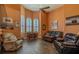 Inviting living room with hardwood floors, ceiling fan, arched windows, and comfortable seating at 304 Hawk Talon Dr, Lithia, FL 33547