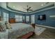 Relaxing main bedroom boasting hard floors, a stylish ceiling fan, and plantation shutters at 304 Hawk Talon Dr, Lithia, FL 33547