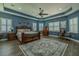 This main bedroom features wood floors, blue accent walls, and a large decorative rug at 304 Hawk Talon Dr, Lithia, FL 33547