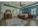 Spacious main bedroom featuring wood floors, a decorative rug, and ample natural light at 304 Hawk Talon Dr, Lithia, FL 33547