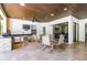 Outdoor kitchen area featuring stainless steel appliances, stone bar and travertine tile flooring at 304 Hawk Talon Dr, Lithia, FL 33547