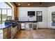 Outdoor kitchen with stainless steel drawers, grill and sink, and large flat screen television at 304 Hawk Talon Dr, Lithia, FL 33547