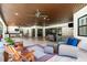 Expansive covered outdoor patio with ceiling fans, lounge chairs, and outdoor dining area at 304 Hawk Talon Dr, Lithia, FL 33547