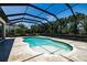 A screened-in pool with travertine tile surround is a refreshing oasis for relaxing and entertaining at 304 Hawk Talon Dr, Lithia, FL 33547