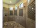 This luxurious walk-in shower features custom tile, lighting and multiple shower heads at 304 Hawk Talon Dr, Lithia, FL 33547