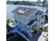 Stunning waterfront home with multiple levels, rooftop deck, and a pool, showcasing luxurious coastal living at 305 Harbor Dr, Indian Rocks Beach, FL 33785