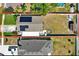 Aerial view of the property showcasing the house layout, backyard space, solar panels, and surrounding neighborhood at 3060 55Th N Ave, St Petersburg, FL 33714