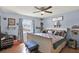 Cozy bedroom features hardwood floors, ceiling fan, comfortable seating, and a large window with backyard view at 3060 55Th N Ave, St Petersburg, FL 33714