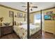 Bright bedroom with sunflower accents, wood floors, a four-poster bed, and a TV in the corner at 3060 55Th N Ave, St Petersburg, FL 33714