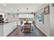 Bright dining area open to the kitchen with granite countertops, tile backsplash, and wood floor at 3060 55Th N Ave, St Petersburg, FL 33714
