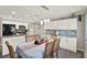 Bright dining area with wood table, stylish pendant lighting, gray backsplash, and modern appliances at 3060 55Th N Ave, St Petersburg, FL 33714
