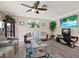 Comfortable living room features a sofa, recliner, entertainment center, decorative artwork, and a ceiling fan at 3060 55Th N Ave, St Petersburg, FL 33714
