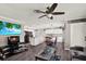 Open-concept living room featuring a ceiling fan, entertainment center, and seamless flow into the kitchen and dining area at 3060 55Th N Ave, St Petersburg, FL 33714