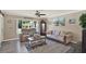 Cozy living room with comfortable seating, a decorative coffee table, and a large window offering natural light and backyard views at 3060 55Th N Ave, St Petersburg, FL 33714