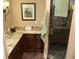 Bathroom with dark cabinets, granite counters and a glass shower door at 324 6Th Ave, Indian Rocks Beach, FL 33785