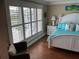Bedroom features hard wood floors, white plantation shutters, and coastal decor at 324 6Th Ave, Indian Rocks Beach, FL 33785