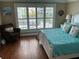 Bedroom features hard wood floors, white plantation shutters, and coastal decor at 324 6Th Ave, Indian Rocks Beach, FL 33785