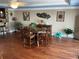 Comfortable dining room with hardwood floors, a wooden table, and coastal-themed decorations at 324 6Th Ave, Indian Rocks Beach, FL 33785