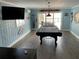 Light blue game room with pool table, television, and coastal themed decor at 324 6Th Ave, Indian Rocks Beach, FL 33785